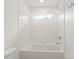Bathroom featuring a soaking tub, white tile surround, and modern fixtures at 2425 Ellen Ave, Charlotte, NC 28208