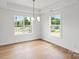 Bedroom with hardwood floors, recessed lighting, and tray ceiling with pendant lighting, creating a serene atmosphere at 2425 Ellen Ave, Charlotte, NC 28208