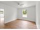 Bright bedroom featuring hardwood floors and a window with neighborhood views at 2425 Ellen Ave, Charlotte, NC 28208