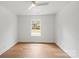 Light-filled bedroom showcasing hardwood floors and a window with neighborhood views at 2425 Ellen Ave, Charlotte, NC 28208