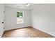 Bedroom featuring hardwood floors, white walls, and a window with backyard view at 2425 Ellen Ave, Charlotte, NC 28208