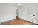 Bright bedroom featuring hardwood floors, white walls, closet, and doorway at 2425 Ellen Ave, Charlotte, NC 28208