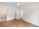Bedroom featuring light hardwood floors, ceiling fan, and ensuite bathroom at 2425 Ellen Ave, Charlotte, NC 28208