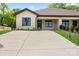 Inviting single-story home showcasing a spacious driveway, manicured landscaping, and a charming brick facade at 2425 Ellen Ave, Charlotte, NC 28208