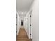 Long hallway featuring hardwood floors, white walls, and multiple doorways at 2425 Ellen Ave, Charlotte, NC 28208