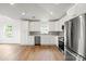 Modern kitchen design showcasing white cabinetry, recessed lighting, stainless steel appliances, and stylish backsplash at 2425 Ellen Ave, Charlotte, NC 28208
