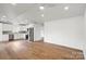 An open layout featuring hardwood floors, recessed lighting, and a modern kitchen design with stainless steel appliances at 2425 Ellen Ave, Charlotte, NC 28208