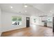 Spacious living room featuring hardwood floors, recessed lighting, with an open layout connecting to the kitchen at 2425 Ellen Ave, Charlotte, NC 28208