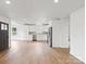 Bright, open layout featuring hardwood floors, recessed lights, seamless transition between kitchen and living area at 2425 Ellen Ave, Charlotte, NC 28208
