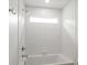Bathroom with shower and tub, featuring a shower head and white brick-style tile at 2429 Ellen Ave, Charlotte, NC 28208