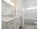 Modern bathroom featuring a vanity with marble countertop, hexagon tile floor and a tub-shower combo at 2429 Ellen Ave, Charlotte, NC 28208