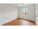 Bedroom featuring hardwood floors, white walls, and a large window with natural light at 2429 Ellen Ave, Charlotte, NC 28208