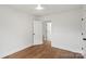Inviting bedroom featuring hardwood floors, neutral walls, and an open doorway to the next room at 2429 Ellen Ave, Charlotte, NC 28208