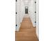 Hallway featuring hardwood floors, white trim, and doors with black hardware at 2429 Ellen Ave, Charlotte, NC 28208