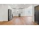 Modern open concept kitchen with white cabinets, hardwood floors and stainless steel appliances at 2429 Ellen Ave, Charlotte, NC 28208