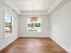 Bright living room featuring hardwood floors, white walls, and modern lighting fixture at 2429 Ellen Ave, Charlotte, NC 28208