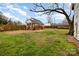 Backyard featuring deck, fencing, outbuilding, mature tree, and fire pit at 306 W 2Nd St, Cherryville, NC 28021