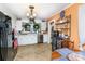 Well-lit kitchen with white cabinets, stainless steel appliances, and a dining area for casual meals at 306 W 2Nd St, Cherryville, NC 28021