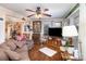 Inviting living room with hardwood floors, ceiling fan, large TV, and cozy furniture for comfortable living at 306 W 2Nd St, Cherryville, NC 28021
