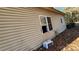 Exterior view of house highlighting open window frame, side of house, and dry yard at 3181 N Olivers Cross Rd, Newton, NC 28658