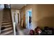 Hallway view with staircase and doorways showcasing interior layout and access to different rooms at 3181 N Olivers Cross Rd, Newton, NC 28658