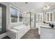 Bright primary bathroom with a soaking tub, walk-in shower, and double sink vanity at 331 Solomon St, Charlotte, NC 28216