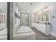 Bright primary bathroom featuring a soaking tub, walk-in shower, and double sinks at 331 Solomon St, Charlotte, NC 28216