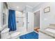 Well-lit bathroom features a classic white subway tile shower, granite vanity, and a blue rug for a pop of color at 331 Solomon St, Charlotte, NC 28216
