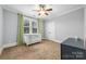 Neutral Bedroom featuring a white crib, ceiling fan, and bright windows at 331 Solomon St, Charlotte, NC 28216