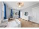 Bright bedroom with blue curtains, a hanging chair, and white furniture complements the room's soothing ambiance at 331 Solomon St, Charlotte, NC 28216