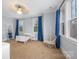 Cozy bedroom features a white bed, ladder shelf, hanging chair, and lots of natural light streaming through the windows at 331 Solomon St, Charlotte, NC 28216