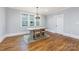Bright dining room with hardwood floors, a rustic chandelier, and three windows at 331 Solomon St, Charlotte, NC 28216