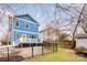 Striking blue two-story home and fenced-in backyard are shown from a rear view at 331 Solomon St, Charlotte, NC 28216