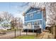 Charming blue home with a spacious backyard and grey deck at 331 Solomon St, Charlotte, NC 28216