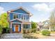 Inviting blue two-story home featuring an orange front door, a well-kept lawn, and a welcoming porch at 331 Solomon St, Charlotte, NC 28216