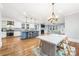 Open-concept kitchen with a blue island, stainless appliances, and a view into the living room at 331 Solomon St, Charlotte, NC 28216