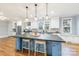 Spacious kitchen features a center island with seating, stainless steel appliances, and hardwood floors at 331 Solomon St, Charlotte, NC 28216