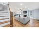 View of the living room connects to the kitchen, with a hardwood staircase at 331 Solomon St, Charlotte, NC 28216