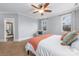 Carpeted main bedroom features a sitting area, windows and ceiling fan at 331 Solomon St, Charlotte, NC 28216