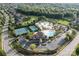 Aerial view of community pool, clubhouse, and tennis courts surrounded by lush landscaping at 409 Running Horse Ln, Waxhaw, NC 28173