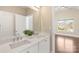 Bathroom features a double vanity with granite countertops, a large mirror, and a door leading to another room at 409 Running Horse Ln, Waxhaw, NC 28173