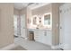 Bright bathroom with double sink, vanity and linen closet at 409 Running Horse Ln, Waxhaw, NC 28173