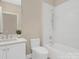 Bright bathroom with a white vanity, modern fixtures, and a shower-tub combination with white tiled walls at 409 Running Horse Ln, Waxhaw, NC 28173