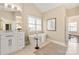 A luxurious bathroom with a standalone tub, a marble top vanity and a large window for natural light at 409 Running Horse Ln, Waxhaw, NC 28173