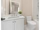 Bathroom featuring a white vanity with a marble countertop, a framed mirror, and a shower/tub combo at 409 Running Horse Ln, Waxhaw, NC 28173