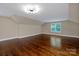 Large bedroom with hardwood floors, neutral walls, a contemporary light fixture, and natural light at 409 Running Horse Ln, Waxhaw, NC 28173