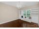 Bedroom featuring a chandelier, hardwood floors, built-in shelving, and a window bench with storage at 409 Running Horse Ln, Waxhaw, NC 28173