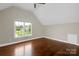 Bedroom with hardwood floors and a large window at 409 Running Horse Ln, Waxhaw, NC 28173