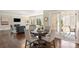 Bright dining area featuring hardwood floors, a modern table setting, and access to the outdoor patio at 409 Running Horse Ln, Waxhaw, NC 28173