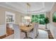 Elegant dining room with natural light, a stylish light fixture, and a view of the backyard at 409 Running Horse Ln, Waxhaw, NC 28173